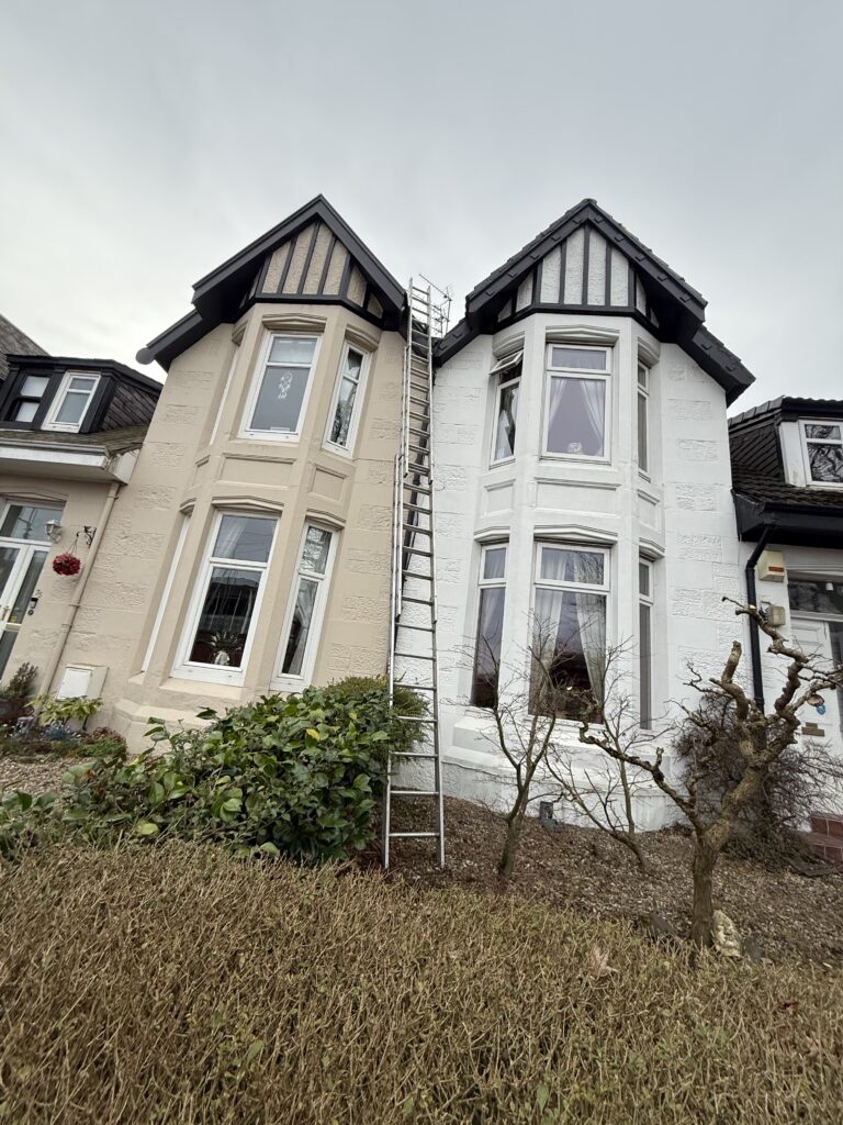 Two adjoining houses with distinct black and white Tudor-style upper facades.